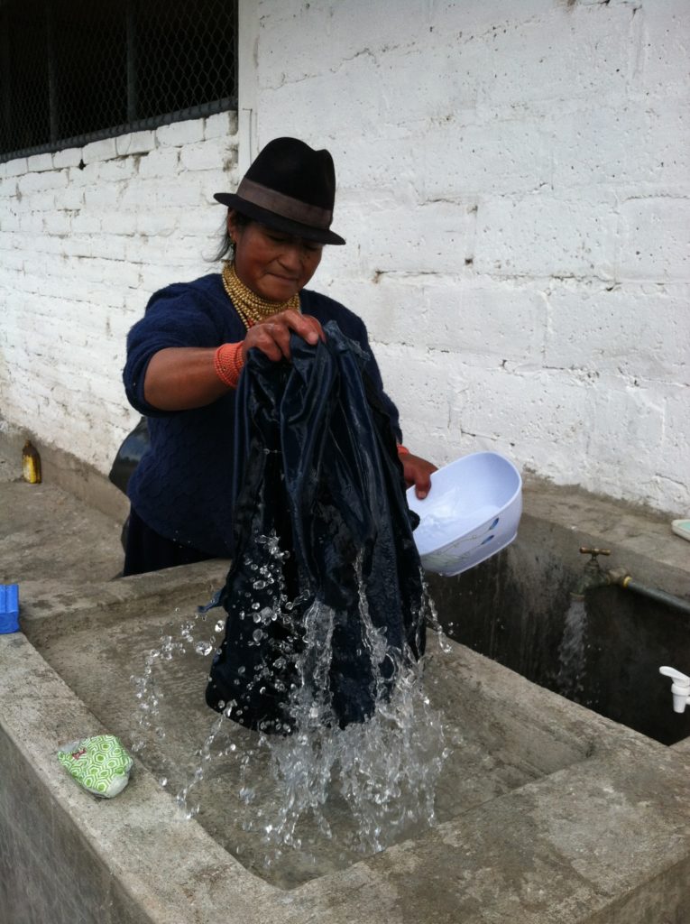 Learning to wash clothing by hand in Ecuador.