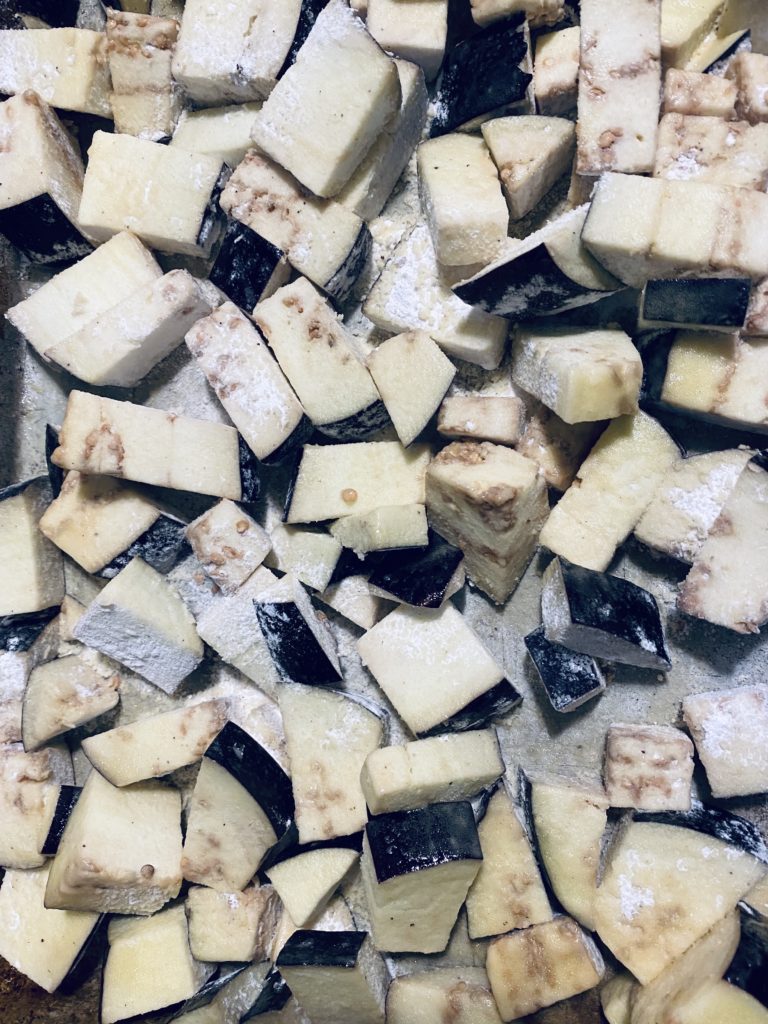 Eggplant dusted with flour ready to be baked for Lemon Eggplant and Rice. 