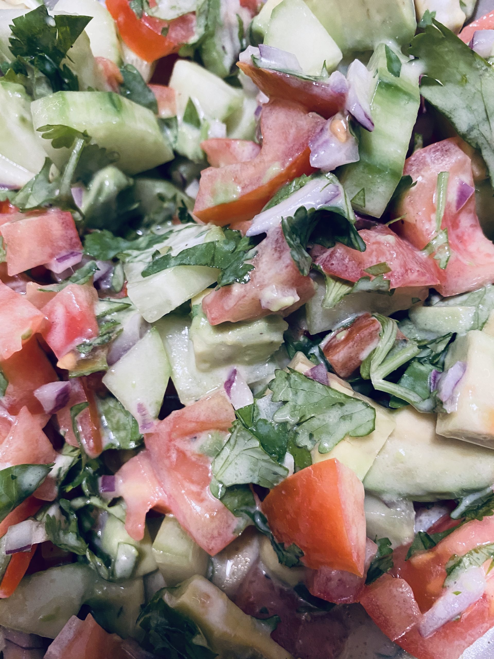 Tomato Avocado Cilantro Salad with Yogurt Lime Dressing ready to be served.