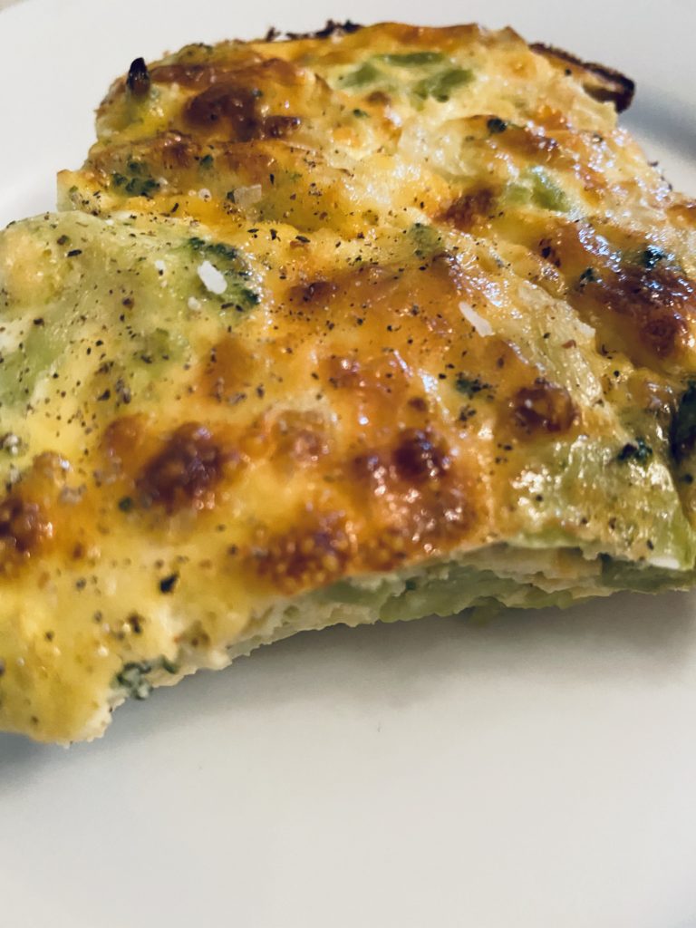 A piece of Broccoli Cheese Egg Bake ready to be enjoyed.