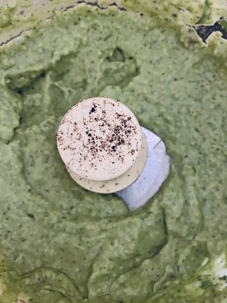 Creamy avocado dip processed in the food processor.