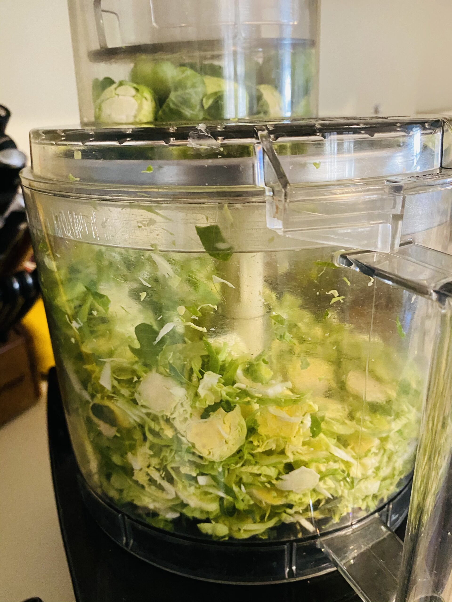 Food processor shaving Brussel sprouts.